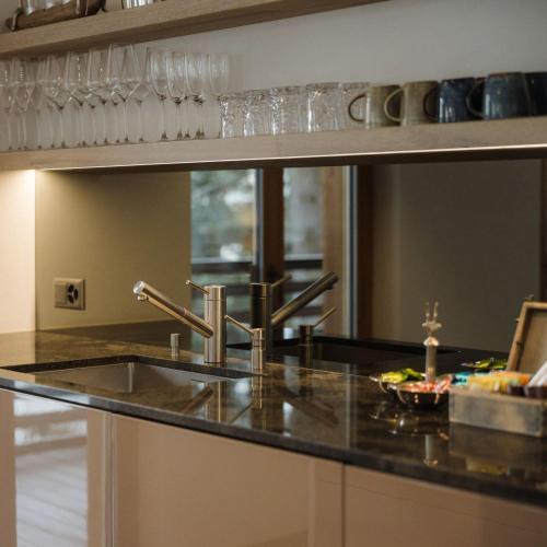 a kitchen with a sink and a counter top at Bergwelt Grindelwald Residence in Grindelwald
