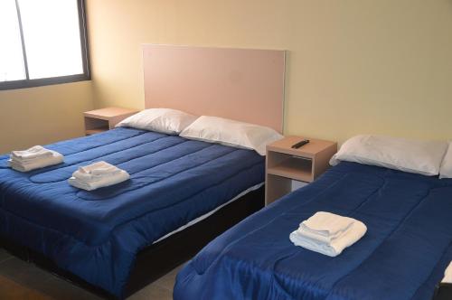 Ένα ή περισσότερα κρεβάτια σε δωμάτιο στο Belgrano Apart Hotel