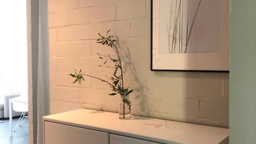 a vase with a plant on top of a counter at Ferienwohnung ZWEI Hof Himmelgrün in Saal