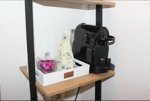 a shelf with a camera and a christmas tree on it at Studio-parking-wifi-Disney-Val d'Europe 10 mn in Montévrain