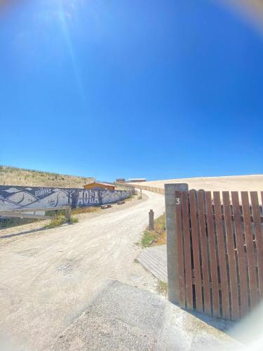 une route vide avec une clôture sur le côté dans l'établissement Maison Familiale en bord de plage, à Lacanau