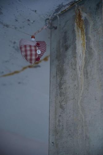 a pink heart shaped light hanging on a wall at Family-Friendly Mörlialp Flat with Views in Giswil