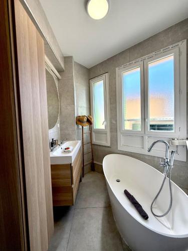 une salle de bain avec une baignoire blanche et un lavabo dans l'établissement Appartement proche palais, à Cannes