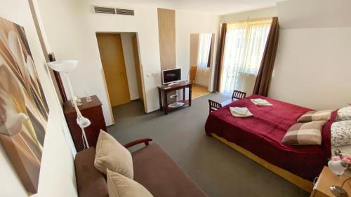 a hotel room with a bed and a television at Kala Thermal Lake Wellness Apartment in Zalakaros