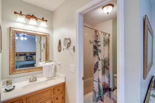 a bathroom with a sink and a mirror at 5 Mi to Pensacola Beach Townhome with Yard! in Gulf Breeze