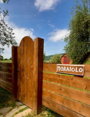 a wooden gate with a sign on a fence at Le Botti Fiorentine in Reggello