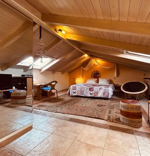 a bedroom with a bed in a room with a wooden ceiling at You & Me, near the sea and Patras University in Patra