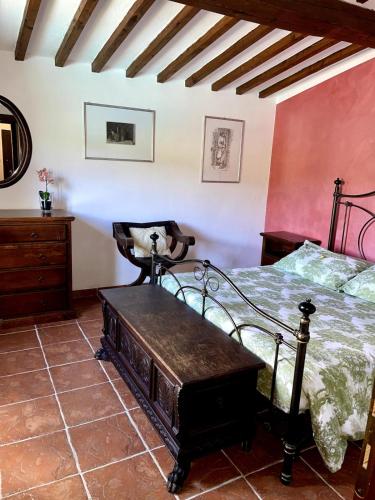 a bedroom with a bed and a wooden table at VillAmato Casa Vacanze ULIVO in Arezzo