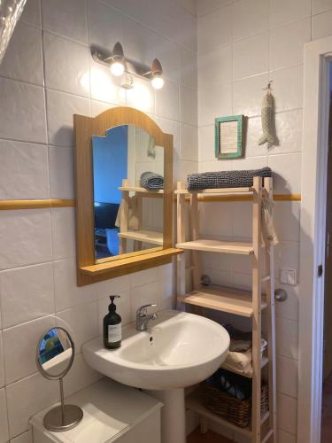 a bathroom with a sink and a mirror at El Racó de Baix in Seva