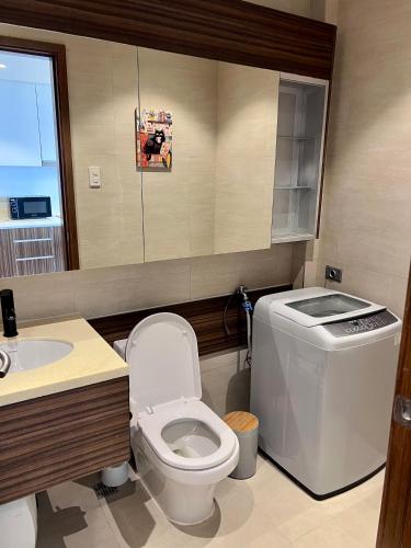 a bathroom with a toilet and a sink at Room in Maribago in Lapu Lapu City
