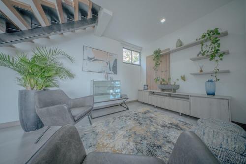 a living room with a couch and chairs and a table at Mountain Mansion Pool, Jacuzzi Epic Medellin View in Envigado