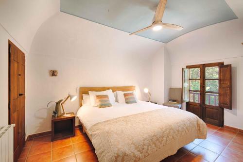 a bedroom with a large bed in a room at Can Cruanyes in Sales del Llierca
