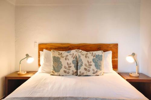 a bedroom with a bed with two lamps on two tables at Can Cruanyes in Sales del Llierca