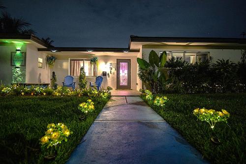 a house with a pathway leading to the front door at Villa Ft Lauderdale XL Pool, playground, BBQ, beach, Family Paradise in Fort Lauderdale