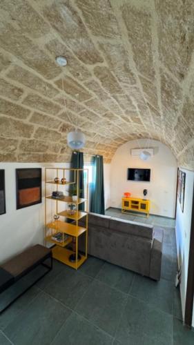 a living room with a stone ceiling and a couch at Casarkeb in Terrasini
