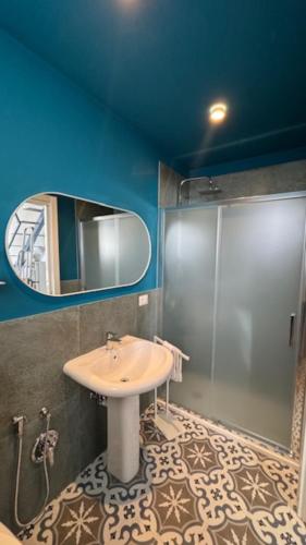 a bathroom with a sink and a mirror at Casarkeb in Terrasini