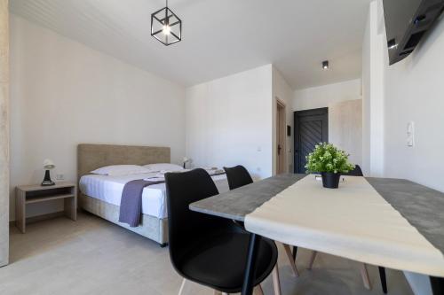 a bedroom with a bed and a table and chairs at NS Apartments Nydri in Nydri