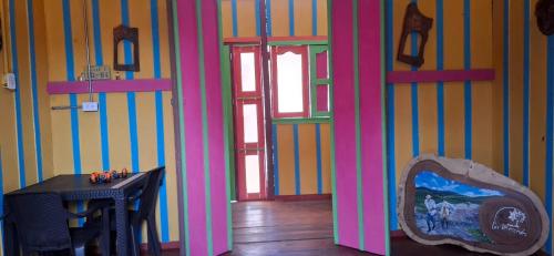 a room with a table and a mirror on a wall at Hostal Restaurante Las Mercedes in Murillo
