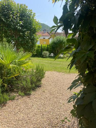 a garden with a house in the background at Le Rocher in Barbazan