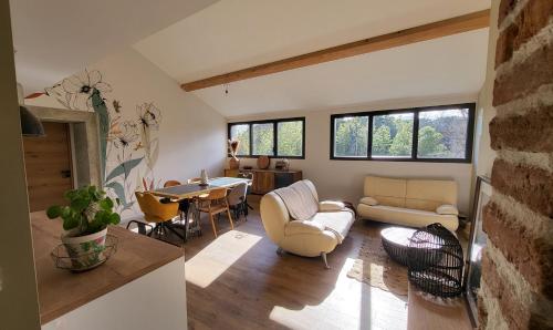 a living room with a couch and a table at BAMBOU SERENITE ECO LOGIS -Piscine in Elne