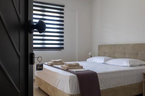 a bedroom with a bed with towels on it at NS Apartments Nydri in Nydri
