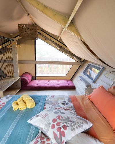 a bed with two pillows on it in a tent at Ciriga Sicily Glamping in Santa Maria Del Focallo