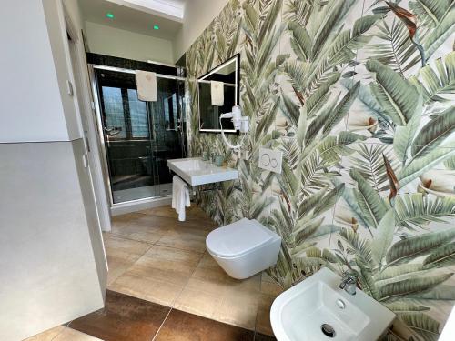 a bathroom with a white toilet and a sink at La Maison Du Soleil Rooms in Agerola