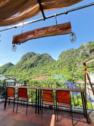 a table with chairs and a view of mountains at Celia Boutique Hotel in Phong Nha