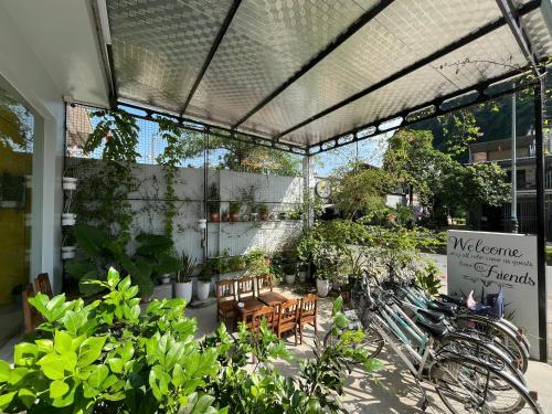 a patio with a bunch of plants and tables and chairs at Celia Boutique Hotel in Phong Nha