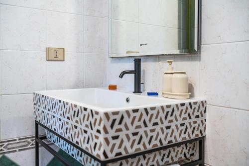 a bathroom with a sink and a mirror at House Levante 28 APT 1 in Pula