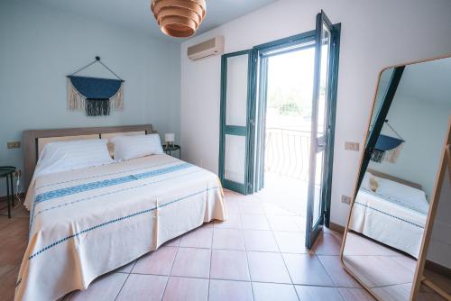 a bedroom with a bed and a large sliding glass door at House Levante 28 APT 1 in Pula