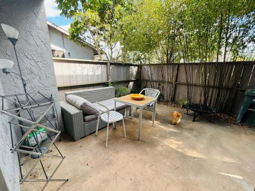 a patio with a table and a couch and a dog at Amazing house in La Jolla in San Diego