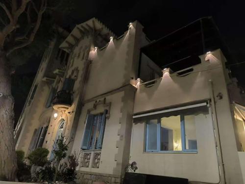 a white house with lights on it at night at Can cruspinera With 6 Bedroom in Tiana