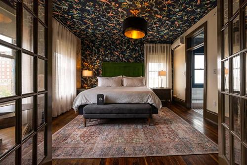 a bedroom with a bed and a couch in it at Hotel Pontotoc in Memphis