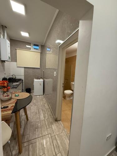 a kitchen with a sink and a toilet in a room at Departamento en vicente López … sentite en tu casa in Florida