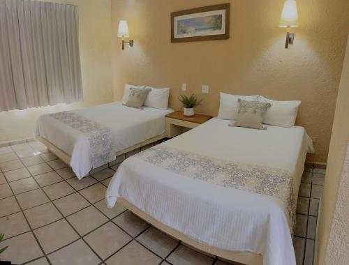Postel nebo postele na pokoji v ubytování Estancia Real Los Cabos