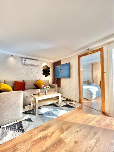 a living room with a couch and a table at Villa 2, Modern Charm Facing Carrousel with Ocean View in Rabat