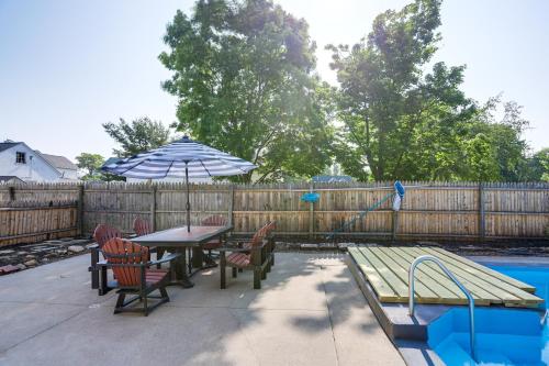 a patio with a table and chairs and an umbrella at Walk to Beach Home with Pool in Vermilion in Vermilion