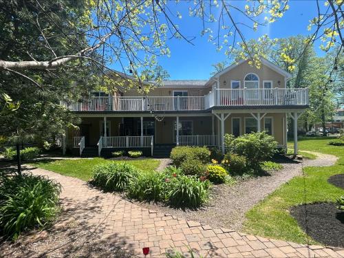 a house with a large porch and a balcony at Fairholm Boutique Inns in Charlottetown