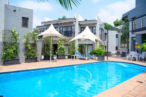 a swimming pool in front of a building at Khayalami Hotel - Mbombela in Nelspruit