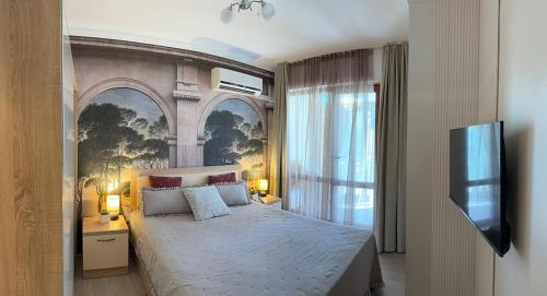 a bedroom with a large bed and a tv at Sea Garden Escape - Byala in Byala