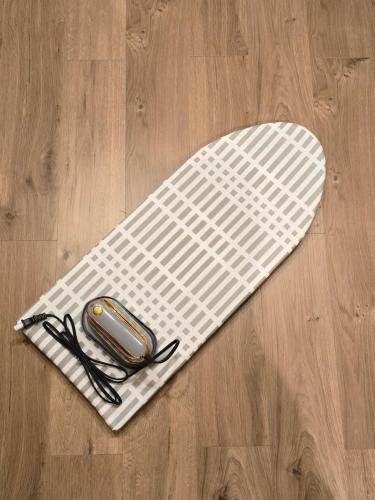 a cell phone sitting on a white mat on a wooden floor at Iriya House 上野 浅草すぐの一軒家貸切ステイ in Tokyo