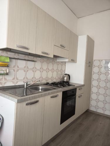 a kitchen with a sink and a stove top oven at A I R Sorrento House 2 in Sorrento