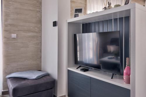 a living room with a flat screen tv in a cabinet at Vision apartmani Vrnjačka Banja in Vrnjačka Banja