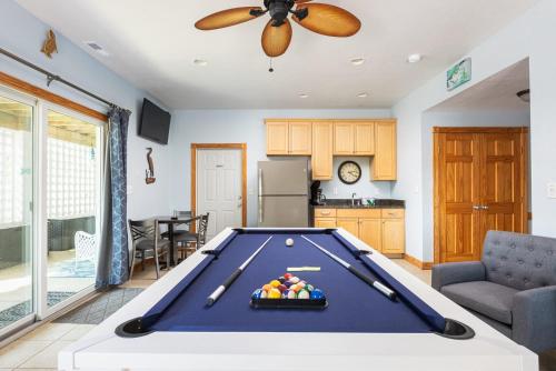 a kitchen with a pool table in a living room at Steps to Beach Pool Game Room Aug Weeks Open in Corolla