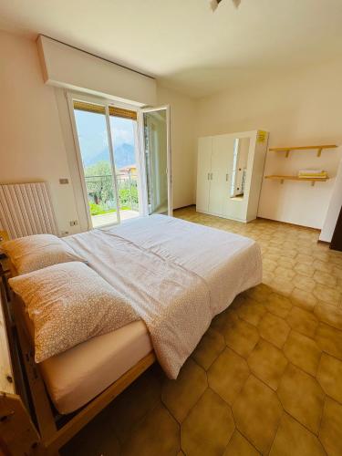 a bedroom with a large bed with a large window at Casa Viktoria in Malcesine