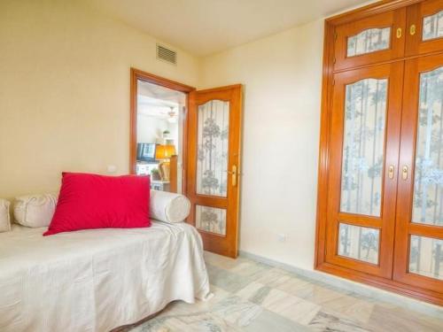 a room with a bed with a red pillow on it at Habitación Silvia Marbella in Marbella