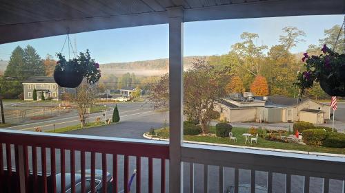 a view of a street from a porch with a window at Cozy Corner Motel in Williamstown