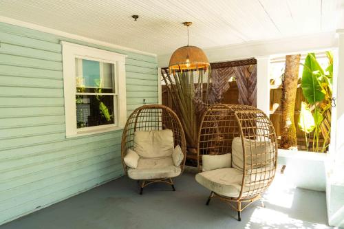 a porch with two chairs and a chandelier at Miami River Inn by Renzzi in Miami