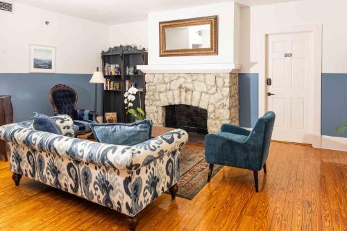 a living room with a couch and a fireplace at Miami River Inn by Renzzi in Miami